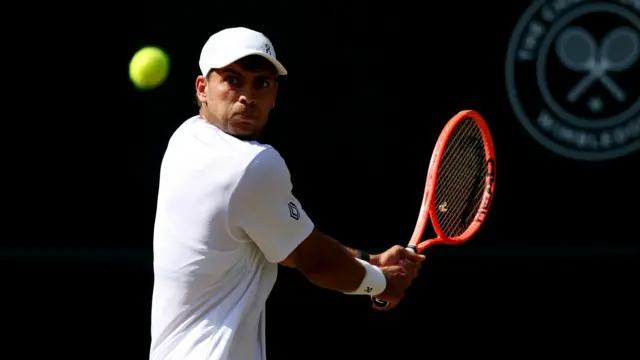 Flavio Cobolli hits a backhand