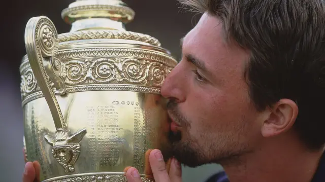 Goran Ivanisevic kisses the Wimbledon trophy