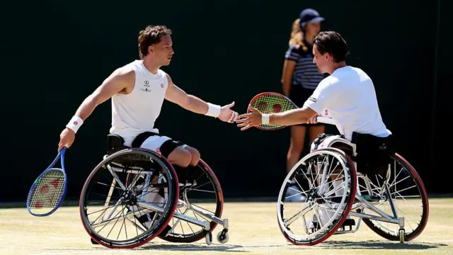 Alfie Hewett (left, facing camera) and Gordon Reid (right, facing away) hi-five