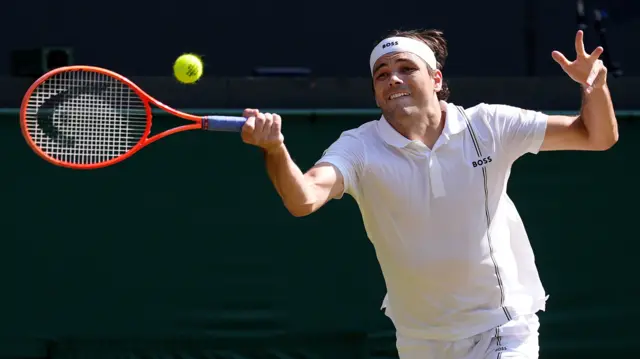 Taylor Fritz hits a forehand