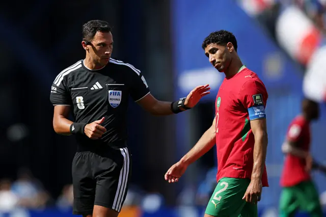 Hakimi chats to the referee