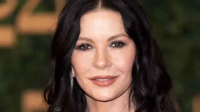 Catherine Zeta-Jones is pictured smiling at the camera.