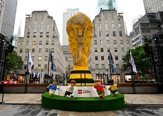 Lego World Cup trophy in front of the Rockefeller building