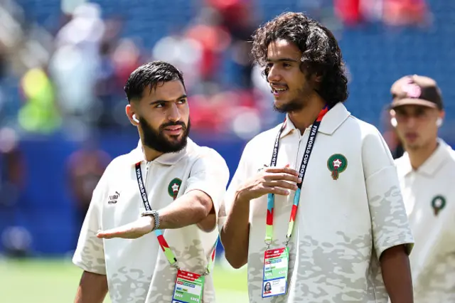 Amine Sbai (L) and midfielder #06 Ayyoub Bouaddi walk on the pitch