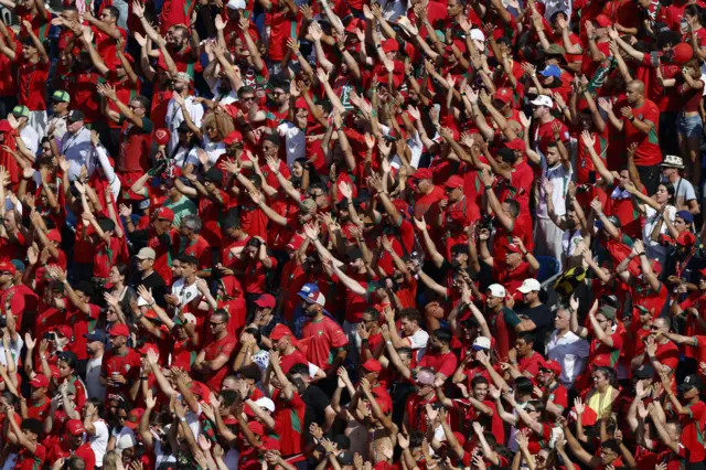 Morocco fans wave and cheer