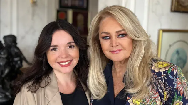 Two women smiling at the camera. One is Bonnie Tyler and the other is BBC journalist Amy Thomas