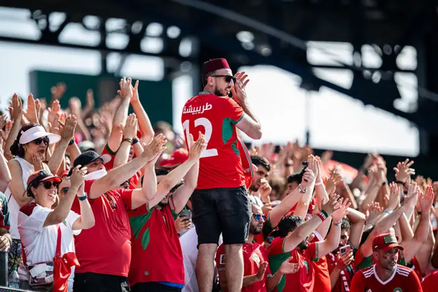 Morocco fans cheer and clap in the stands