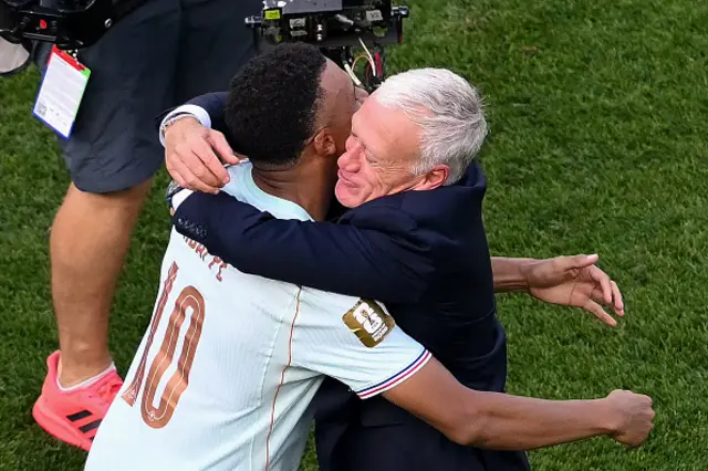 Kylian Mbappe hugs France's head coach Didier Deschamps