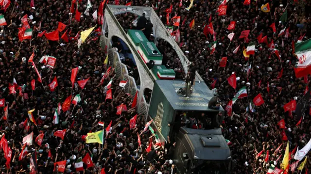 Mourners gather around a vehicle transporting the coffin of Iran's late Supreme Leader Ayatollah Ali Khamenei, who was killed on February 28 in Israeli and U.S. airstrikes, and his family members, on the day of his burial, in a culmination of a mass funeral, in Mashhad, Iran, July 9, 2026