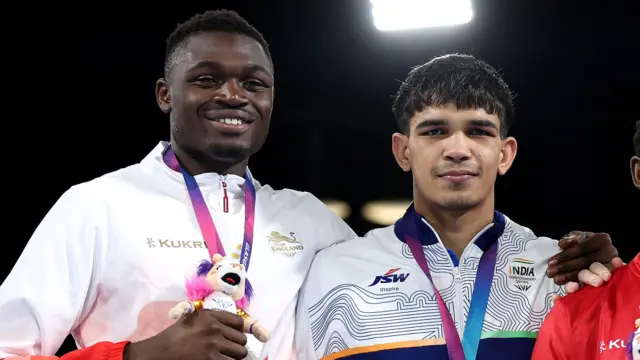 Dimeji Shittu smiles while holding his silver medal