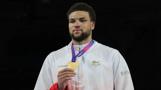 England's Damar Thomas holds up his gold medal