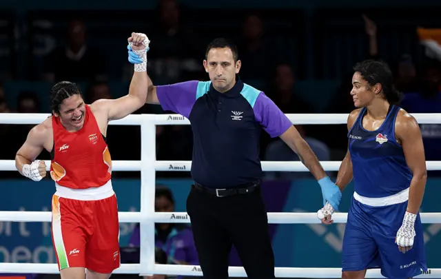 India's Arundhati Choudhary has her arm raised as the winner over Chantelle Reid (right)
