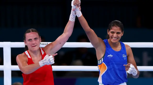 Michaela Walsh points to Jaismine Lamboria as they hold their hands up together after the women's 57kg final
