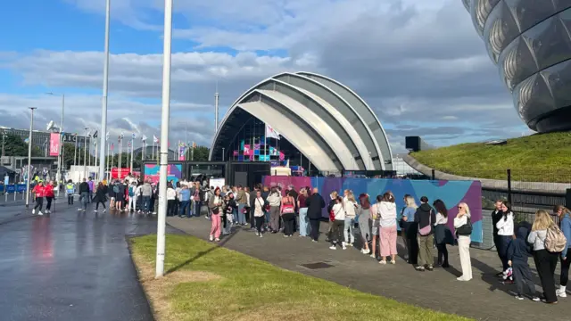 Fans queue to get into the Netball venue.