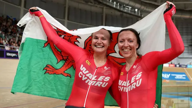 Anna Morris and Jess Roberts with the Welsh flag
