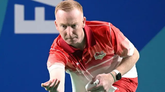Nick Brett of Team England bowls in action against Canada