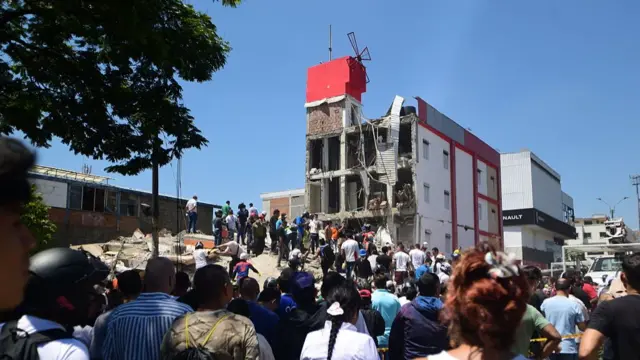 Residents inspect damaged buildings after a magnitude 7.4 earthquake struck Colombia, killing at least 111 people and injuring 87 others, in Cali, Colombia, on August 10, 2026.