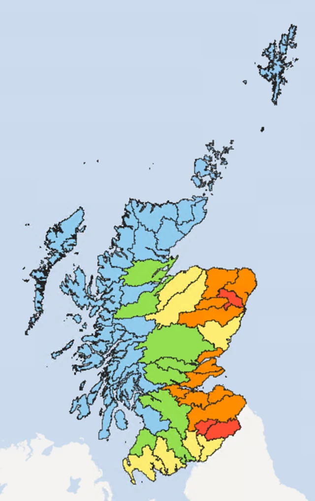 A map of Scotland with areas highlighted in red, orange, yellow, green and blue indicating the level of water scarcity in the area. Red indicates significant scarcity, while blue indicates normal conditions.