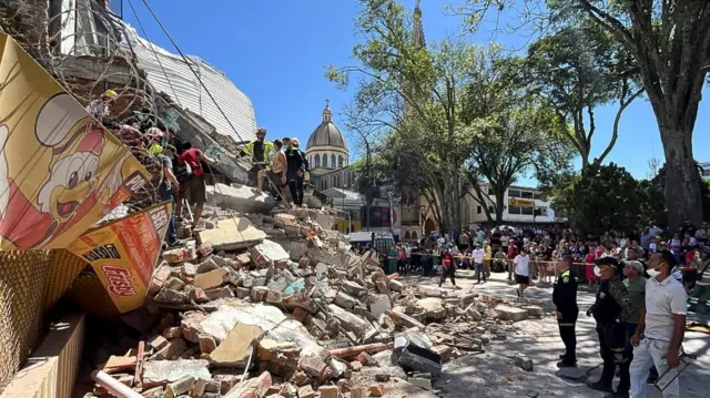 Residents and emergency personnel dig through the debris of a partially collapsed building after an earthquake, in Pereira, Colombia August 10, 2026