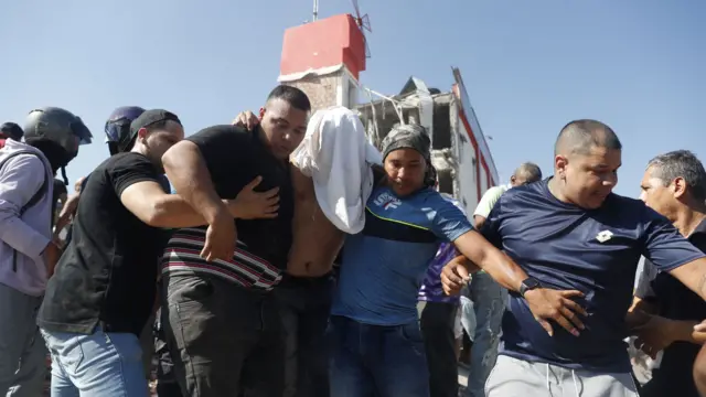 People being evacuated from a collapsed building after an earthquake in Cali, Colombia,