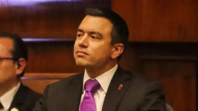 Daniel Noboa Azin is pictured wearing a dark suit, white shirt and purple tie.
