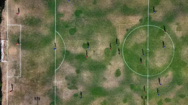 An aerial view of a football pitch after weeks of no significant rain