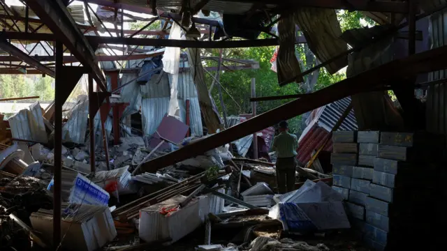 An employee stands among debris at a compound of the City Children's Clinical Infectious Disease Hospital, which was hit by an overnight missile strike, amid Russia's attack on Ukraine, in Kyiv, Ukraine August 11, 2026