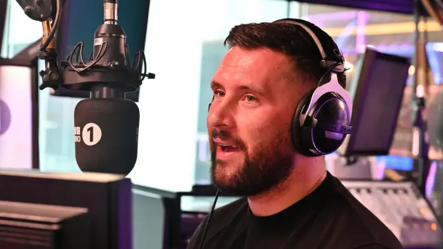Radio 1 DJ Danny Howard wearing headphones