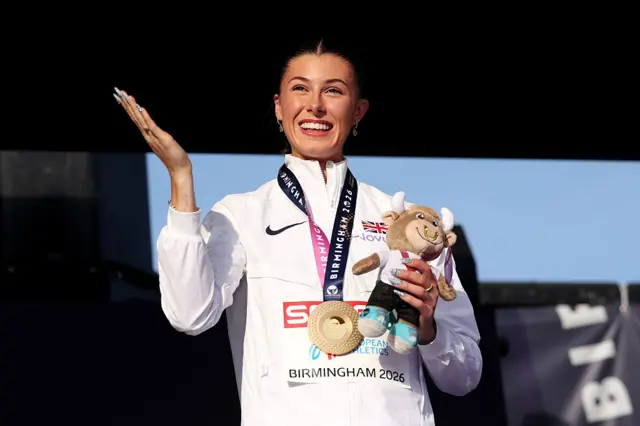 Amy Hunt celebrates at the medal ceremony