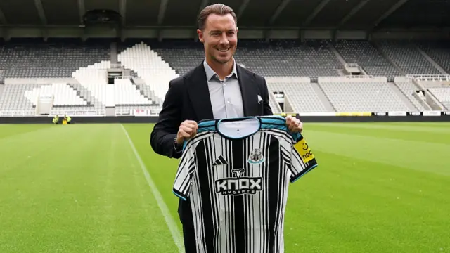 Matthias Jaissle holding a Newcastle United shirt