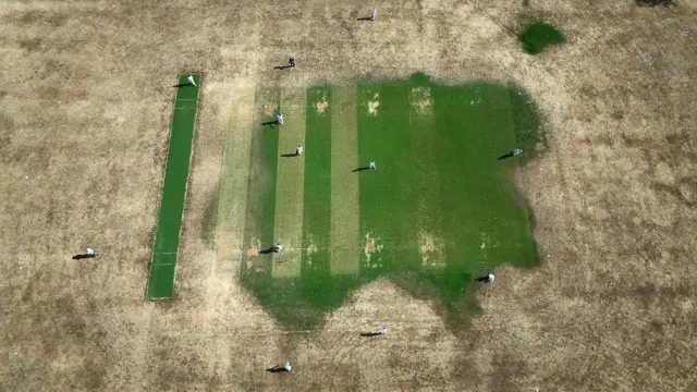 An aerial view taken with a drone shows a drought-damaged cricket pitch in Cockfosters, North London,