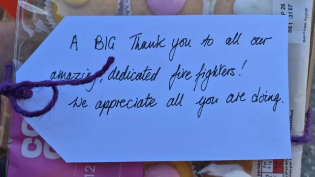 A note on a pack of cupcakes saying 'A BIG thank you to all our amazing, dedicated firefighters! We appreciate all you are doing."