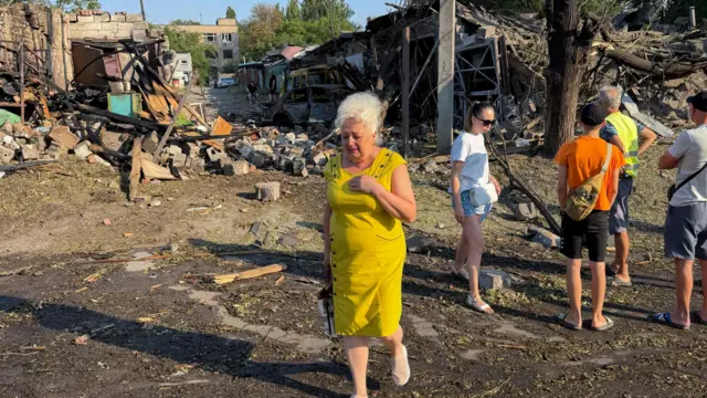 Local people view the site of a Russian attack on a residential area in Zaporizhzhia, Ukraine, 11 August 2026