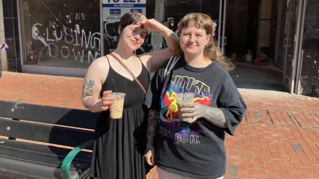 Mallory (left) and Madeleine (right) wearing a dress and the other a t shirt and shorts