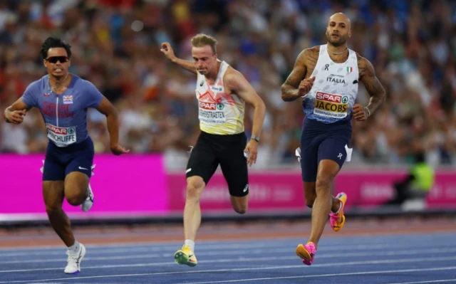 Italy's Lamont Marcell Jacobs crosses the line to win the men's 100m semi final