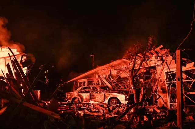 A firefighter works at the site of a car garages of residents which were hit by an overnight Russian missile strike, amid Russia's attack on Ukraine, in Zaporizhzhia, Ukraine August 11, 2026