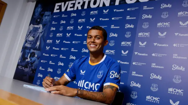 Brennan Johnson signing contract in Everton shirt