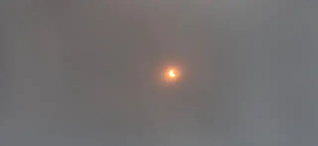 A tiny bright shining moon during the eclipse in Greenland