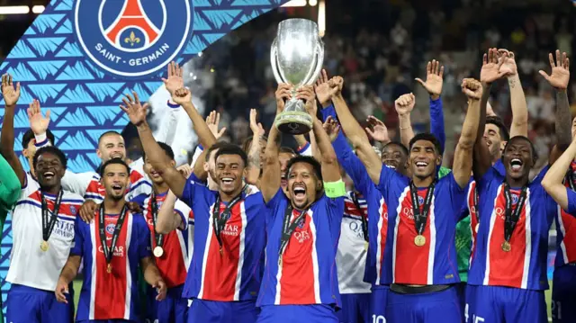 Marquinhos of Paris Saint-Germain lifts the UEFA Super Cup trophy after his team's victory in the UEFA Super Cup 2026 match between Paris Saint-Germain and Aston Villa at Stadion Salzburg.