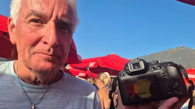 Man showing picture of eclipse he's taken in Cornwalll