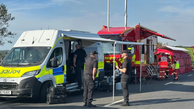 A police van and fire truck at the scene of the fire