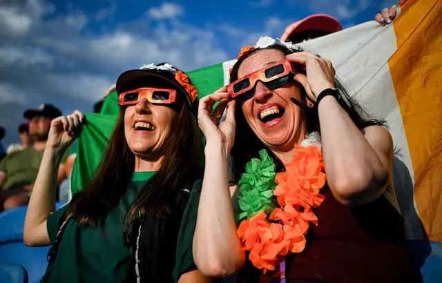 Supporters watch the solar eclipse during day three of the European Athletics C