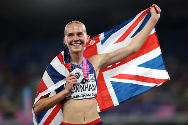 Silver medalist, Emily Newnham of Team Great Britain, celebrates with her medal and the national flag after the Women's 400m Hurdles Final during day three of the 27th European Athletics Championships at Alexander Stadium on August 12, 2026 in Birmingham, England