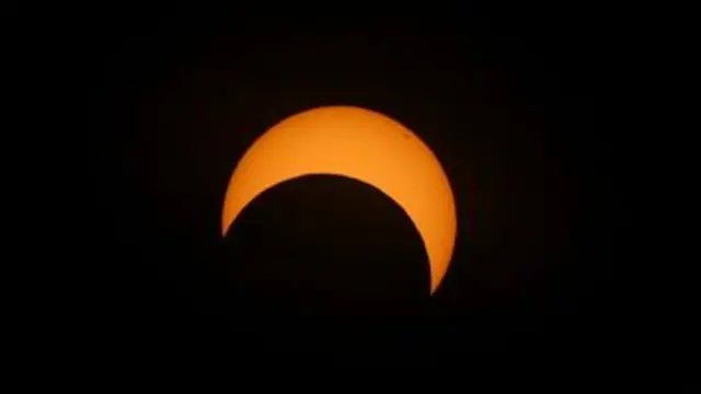 The sun is partially covered by the moon.