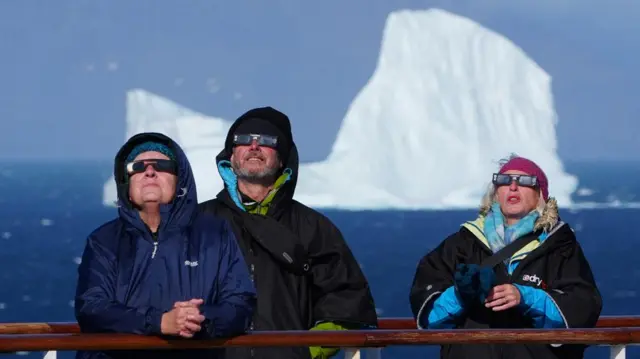 Passengers on a cruise ship watching the eclipse off the coast of Greenland.