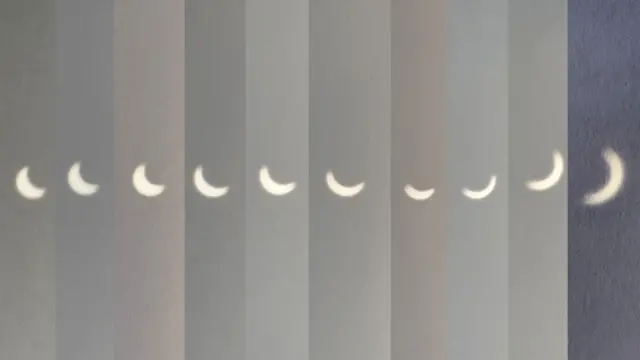 A composition of pictures of the solar eclipse reflected onto the inside of a box, with the Sun in a variety of crescent shapes.