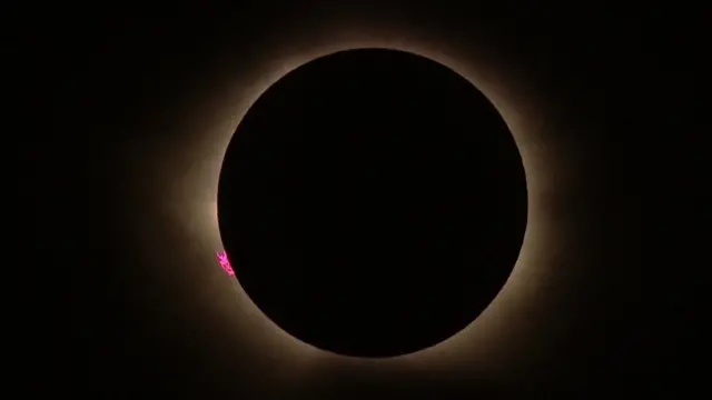 A total solar eclipse, with the glare of the Sun shining around the Moon