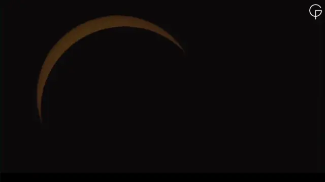 The Sun appears in a crescent shape against a dark background.