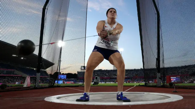 Charlotte Payne in mid-swing before releasing the hammer