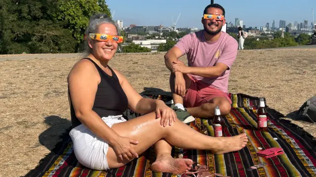 Alfredo Piter and his Aunt Nancy on Primrose Hill ahead of the partial eclipse